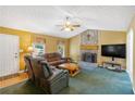 Cozy living room with a stone fireplace, comfortable seating, and a ceiling fan at 198 Wiley Dr, Douglasville, GA 30134