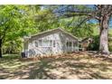 Well-manicured yard of brick house with white trim and shutters under a canopy of trees at 2925 Heather Dr, Atlanta, GA 30344