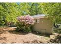 Backyard view showcasing a lush azalea bush, brick exterior, and partial fence line at 2925 Heather Dr, Atlanta, GA 30344