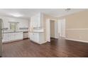 Bright kitchen with white cabinets, stainless steel appliances, granite countertops, and dark hardwood flooring at 2925 Heather Dr, Atlanta, GA 30344
