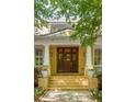 Elegant front entrance with a custom wood door, brick steps, and decorative planters at 334 Sutherland Ne Pl, Atlanta, GA 30307
