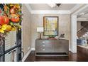 Stylish entryway with herringbone wallpaper, console table, and dark wood flooring at 3127 Lenox Ne Rd # 20, Atlanta, GA 30324
