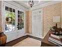 Cozy study featuring patterned wallpaper, French doors, and shuttered windows at 3127 Lenox Ne Rd # 20, Atlanta, GA 30324