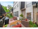 Outdoor patio with brick accent wall, wicker furniture, and a grill, perfect for entertaining at 5105 Chemin De Vie, Atlanta, GA 30342