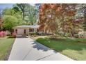 Inviting one-story home with a spacious front yard, attractive landscaping, and long driveway at 2469 Hunting Valley Dr, Decatur, GA 30033