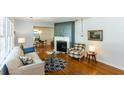 Cozy living room with fireplace, hardwood floors, and an open view into the dining area at 2469 Hunting Valley Dr, Decatur, GA 30033