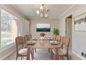 Elegant dining room featuring a large window and seating for eight at 2636 Harvest Se Dr, Conyers, GA 30013