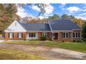 Beautiful brick home with black shutters and a well-manicured lawn at 2636 Harvest Se Dr, Conyers, GA 30013