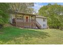 A charming home boasts a lovely covered porch with an inviting red front door at 4973 Gunners Ne Pass, Roswell, GA 30075