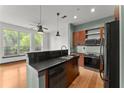 Open kitchen featuring stainless steel appliances, granite counters and breakfast bar with hardwood floors at 747 Ralph Mcgill Ne Blvd # 223, Atlanta, GA 30312