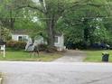 Cozy single-story home nestled among mature trees with a private driveway and well maintained front yard at 2771 Georgian Dr, Brookhaven, GA 30341