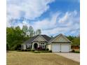 Charming, light yellow single-story home with well-maintained lawn and shrubbery plus an attached two-car garage at 59 Sentry Rdg, Dallas, GA 30157