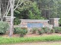 Stone community welcome sign with 'Legacy at St. Joseph's' engraved on a blue plate at 7431 St David St, Fairburn, GA 30213