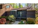 Beautiful exterior with stone accents and manicured flower beds leading to a dark-colored, inviting entrance at 859 Bridgewater Ct, Stone Mountain, GA 30088
