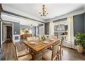 Open concept dining room with natural light, a wooden table, and hardwood flooring at 924 Woodbury Rd, Canton, GA 30114