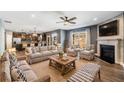 Spacious living room featuring hardwood floors, fireplace, ceiling fan, and plenty of natural light at 924 Woodbury Rd, Canton, GA 30114