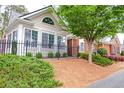 Beautiful home featuring a landscaped front yard, black metal fence, and manicured bushes at 1535 Duluth Hwy # 1104, Lawrenceville, GA 30043