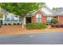 Charming brick home featuring a landscaped front yard, black trim windows, and manicured bushes at 1535 Duluth Hwy # 1104, Lawrenceville, GA 30043