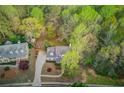 Expansive aerial view of a well-maintained home nestled among lush greenery and mature trees at 657 Swans Landing Dr, Dacula, GA 30019