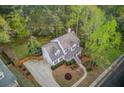Desirable neighborhood home with well-manicured landscaping, large driveway, and inviting front porch at 657 Swans Landing Dr, Dacula, GA 30019