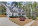 Traditional home with a white exterior, a spacious driveway, and a charming, covered front porch at 657 Swans Landing Dr, Dacula, GA 30019