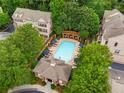 Beautiful aerial view of a community pool with lounge chairs and gazebo surrounded by lush greenery and well-kept buildings at 1012 E Paces Chase, Atlanta, GA 30326