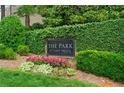 Well-maintained community sign surrounded by lush greenery and colorful flowerbeds at 1012 E Paces Chase, Atlanta, GA 30326