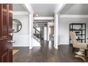 Inviting foyer with dark wood floors, white trim, and an open view of the staircase at 1054 Georgian Point Dr, Lawrenceville, GA 30045