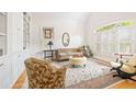 Inviting living room with large windows, plantation shutters, built-in shelving, and comfortable seating at 221 Streamside Ct, Lilburn, GA 30047