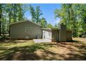 Exterior view of the rear of the house, highlighting the concrete patio and spacious yard at 5844 Earlwane Dr, Lithonia, GA 30058