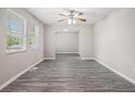 Bright living room featuring stylish gray wood-look flooring and neutral paint at 5844 Earlwane Dr, Lithonia, GA 30058