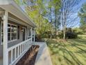 View of the home's front porch overlooking the lawn and street at 175 Stoneview Cir, Covington, GA 30016