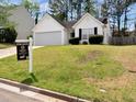 Charming single-story home with a well-manicured lawn and attached two-car garage at 2329 Wavetree Nw Ln, Acworth, GA 30101