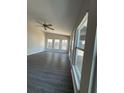 Bright living room featuring modern ceiling fan and multiple windows at 4049 Heritage Valley Ct, Norcross, GA 30093