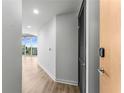 Modern hallway with wood flooring, leading to a balcony with city views at 860 Peachtree Ne St # 2118, Atlanta, GA 30308