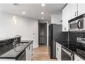 Updated kitchen featuring stainless steel appliances, white cabinets, and dark countertops at 860 Peachtree Ne St # 2118, Atlanta, GA 30308