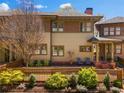 Charming exterior view of a home featuring a brick chimney, fenced yard, and inviting front porch at 1181 Cleburne Ne Ave, Atlanta, GA 30307