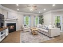 Cozy living room with a fireplace, plush seating, and natural light streaming through the windows at 138 Bryon Ln, Acworth, GA 30102