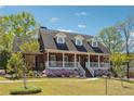 Beautiful brick home with a welcoming front porch and colorful flower beds at 255 Helens Manor Dr, Lawrenceville, GA 30045
