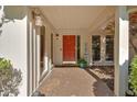 Inviting entryway with a vibrant red door, sidelights, and decorative plants at 30 Sweetwood Ct, Roswell, GA 30076
