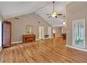 Open-concept living area with vaulted ceilings, wood floors, and ample natural light at 30 Sweetwood Ct, Roswell, GA 30076