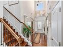 Elegant foyer with hardwood floors, a staircase, and a view of the front door at 4015 Two Bridge Ct, Buford, GA 30518