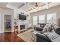 Cozy living room featuring a fireplace, coffered ceilings, and ample seating at 4015 Two Bridge Ct, Buford, GA 30518