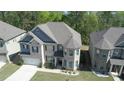 Aerial view of a beautiful two-story home with well-maintained lawn and complementing landscape at 550 Breton Highlands, Fairburn, GA 30213