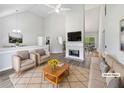 Bright living room with high ceilings, fireplace, and stylish neutral furnishings at 10924 Hondal Ct, Hampton, GA 30228