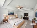 Spacious main bedroom featuring tray ceilings and an ensuite bathroom at 10924 Hondal Ct, Hampton, GA 30228