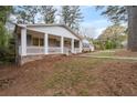 Beautiful brick home showcasing a spacious front porch and a meticulously landscaped front yard, perfect for relaxation at 2000 Hill Rd, Marietta, GA 30062