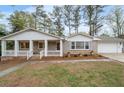 Inviting brick home featuring a delightful front porch, columns and manicured landscaping enhancing its curb appeal at 2000 Hill Rd, Marietta, GA 30062