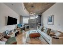 Cozy living room with neutral tones, a modern ceiling light, and large windows showcasing the city skyline at 400 W Peachtree Nw St # 3114, Atlanta, GA 30308