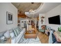 Open concept living space featuring hardwood floors, a modern kitchen, and a comfortable living area at 400 W Peachtree Nw St # 3114, Atlanta, GA 30308